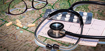 stethoscope lying on top of a map